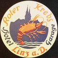 Roter Krebs Hotel Linz Austria circular luggage label with orange crayfish and dark city skyline