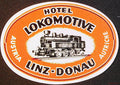 Oval orange Hotel Lokomotive Linz Austria luggage label with black steam locomotive
