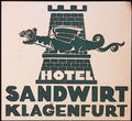 Hotel Sandwirt Klagenfurt luggage label with dark green winged dragon and brick tower