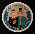 Circular Hotel Steirerhof Graz Austria luggage label featuring a couple in traditional dress and a green ribbon