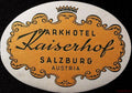 Oval Parkhotel Kaiserhof Salzburg Austria luggage label with golden-yellow ornamental cartouche, crown and black lettering