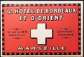Red Grand Hôtel de Bordeaux et d’Orient Marseille luggage label with a cream cross and chequered border